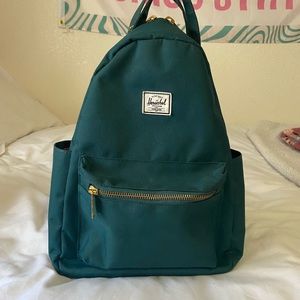 Dark olive green mini backpack.